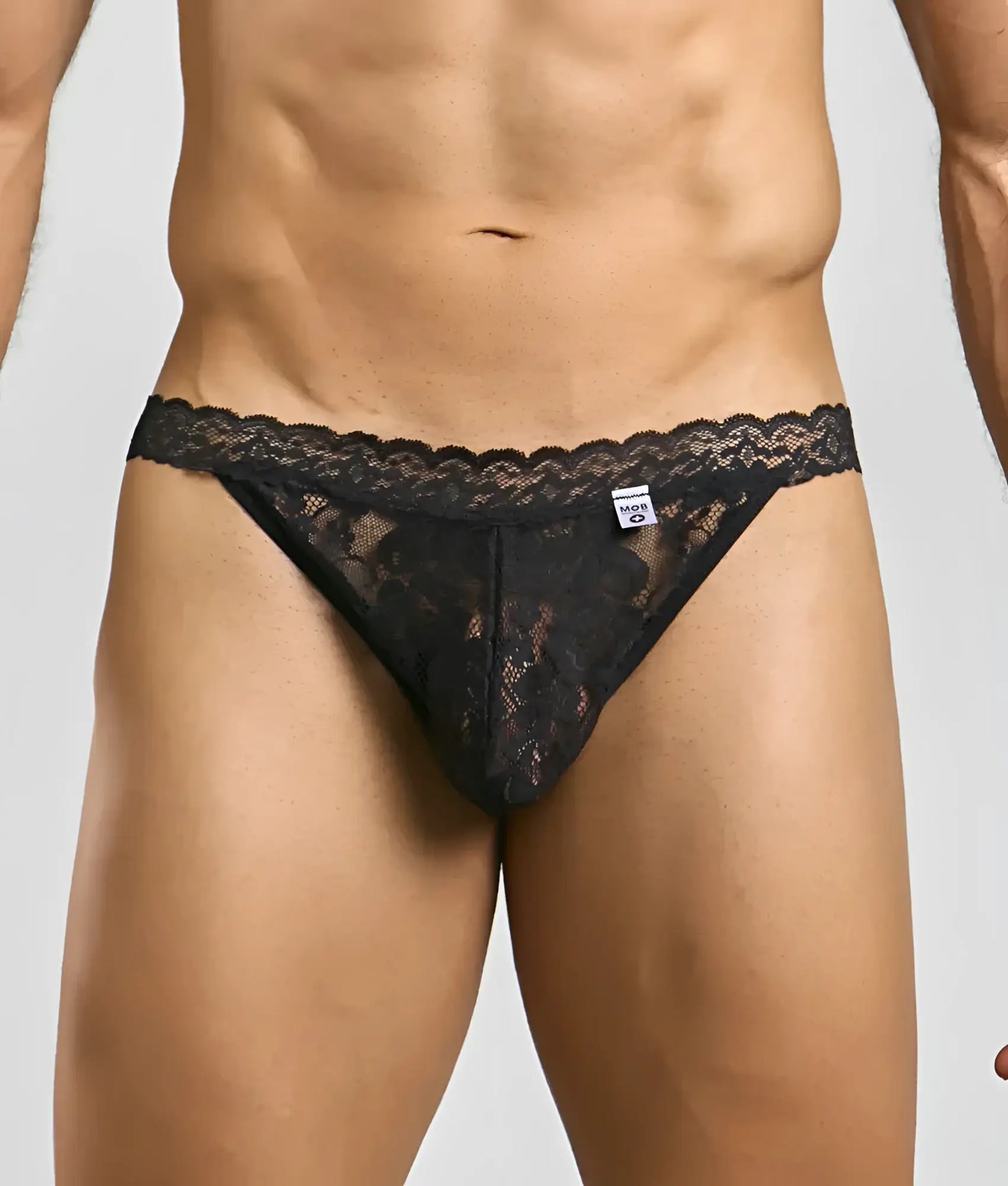 Black lace thong with intricate floral patterns and scalloped edge from mob men’s lace jockstrap collection