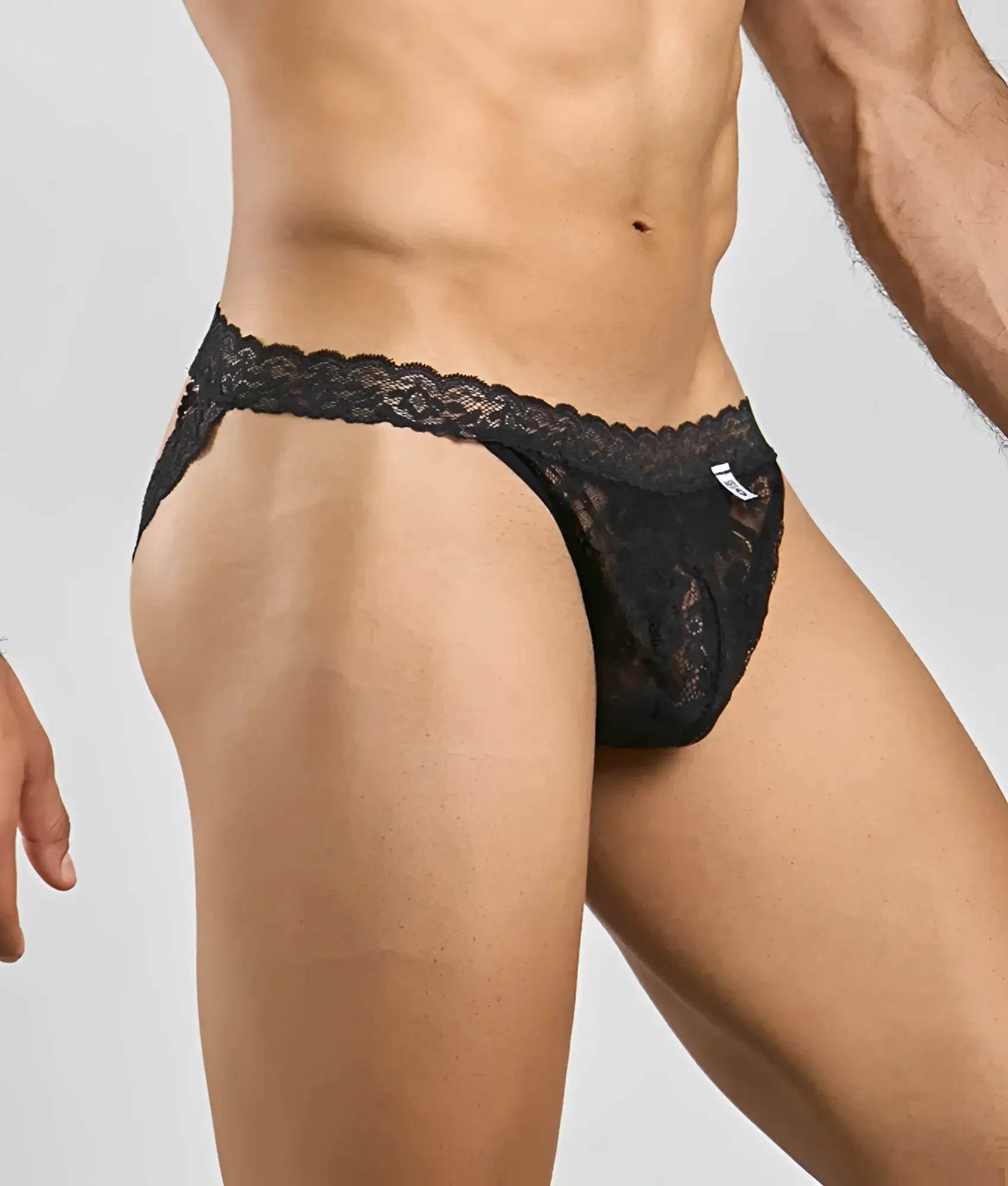 Black lace thong with intricate floral patterns and scalloped waistband in MOB men’s lace jockstrap design