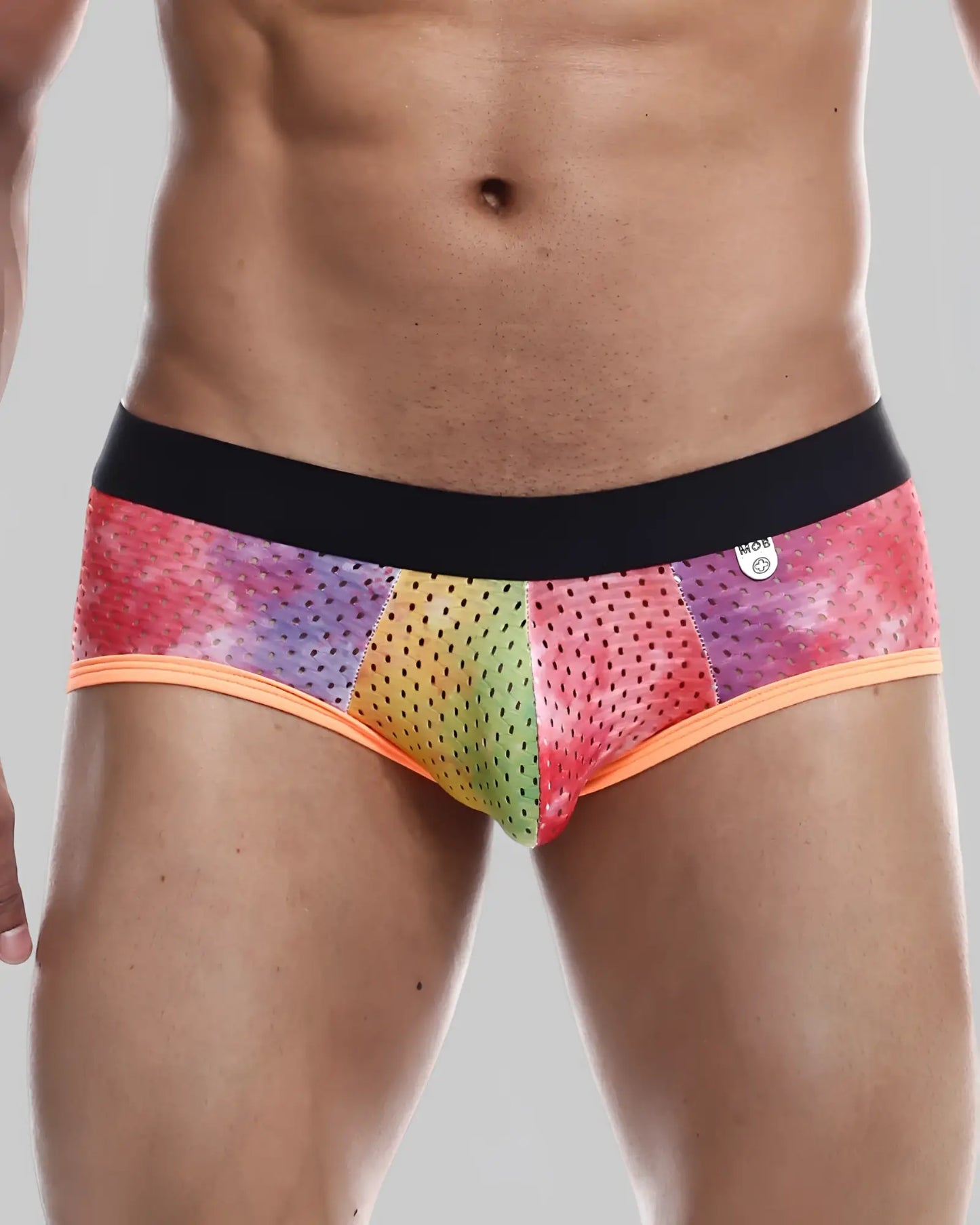 Mob aero brief rainbow-colored mesh men’s briefs with black waistband and orange trim showing front side