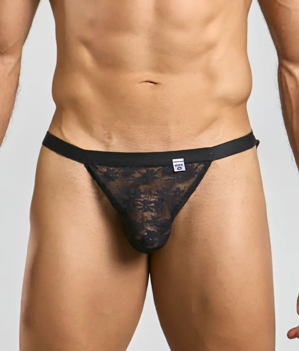 Black lace MOB Y sexy thong with a solid black waistband and floral pattern shown from the back side