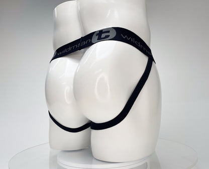 White WildmanT jockstrap on a mannequin, featuring a black branded waistband and leg straps.