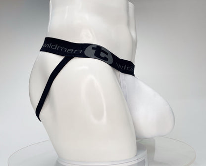 White jockstrap on a mannequin with a large pouch and a black branded waistband featuring the WildmanT logo.