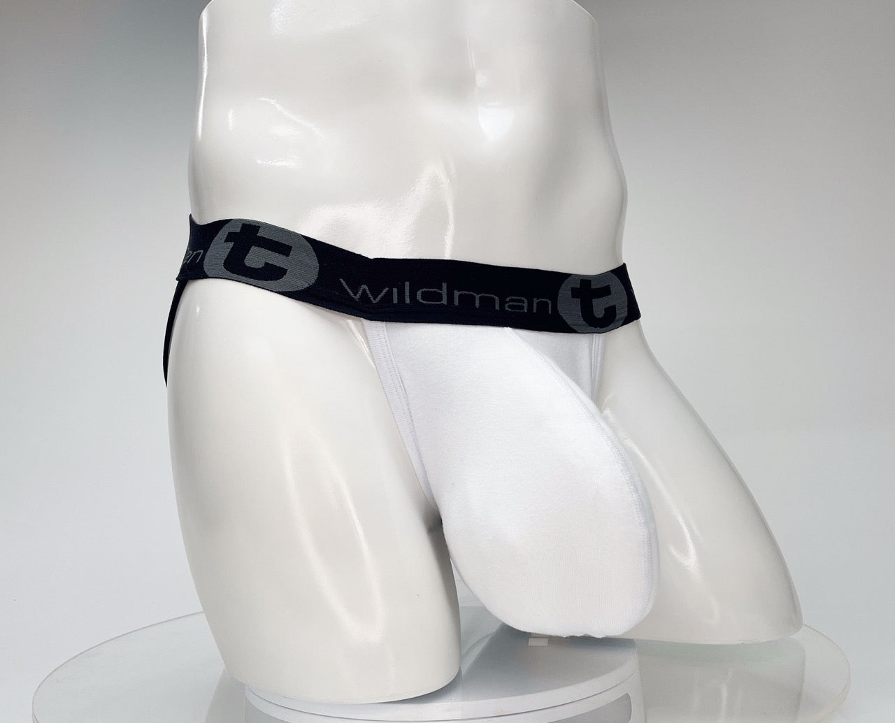 White WildmanT cotton jockstrap on a mannequin, featuring a black waistband with "wildman t" branding.