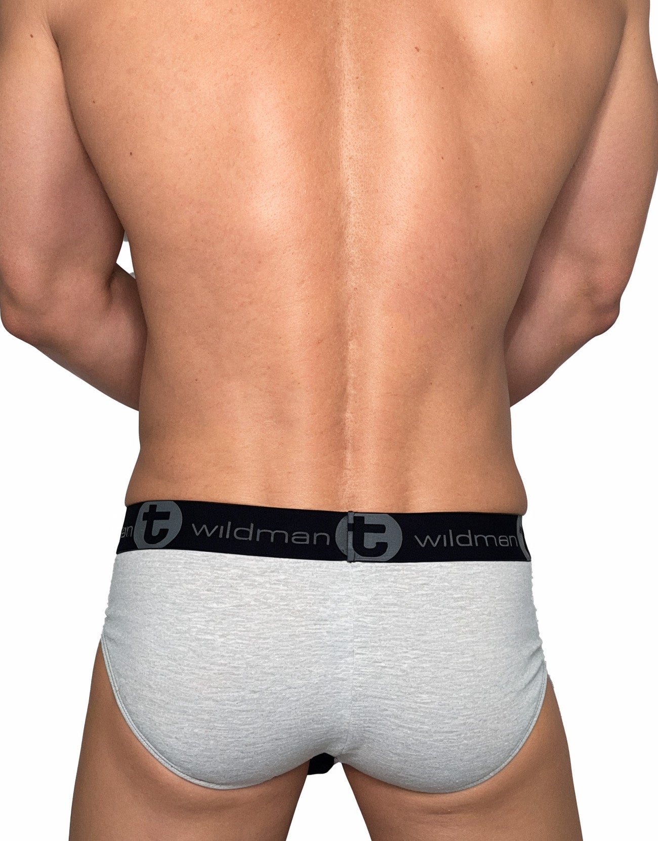 Back view of a man wearing gray cotton briefs with a black elastic waistband featuring the WildmanT logo.
