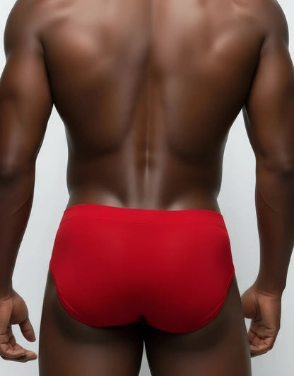 Back view of a man wearing red mesh briefs with a solid waistband.
