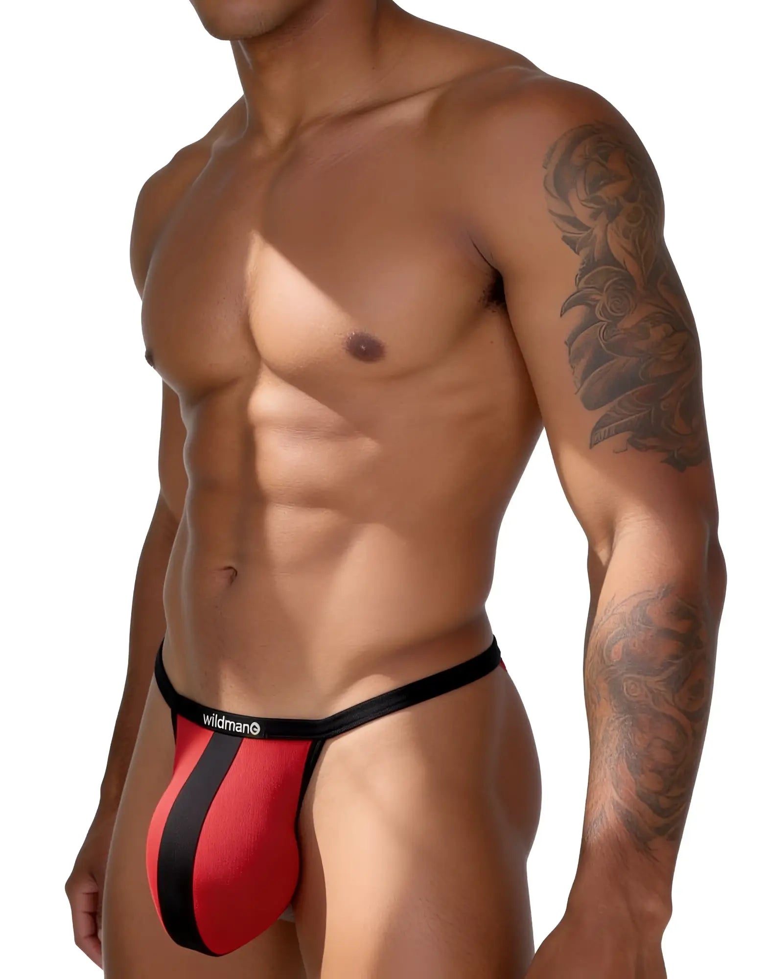 Red mesh thong with a vertical black stripe and black waistband featuring the "Wildman" logo on a fit, tattooed man.