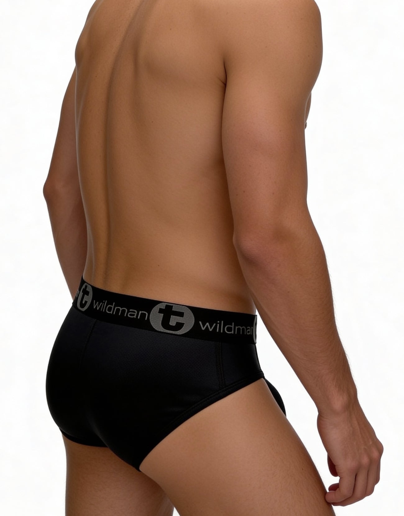 Back view of a man wearing black mesh briefs with a branded "WildmanT" elastic waistband.
