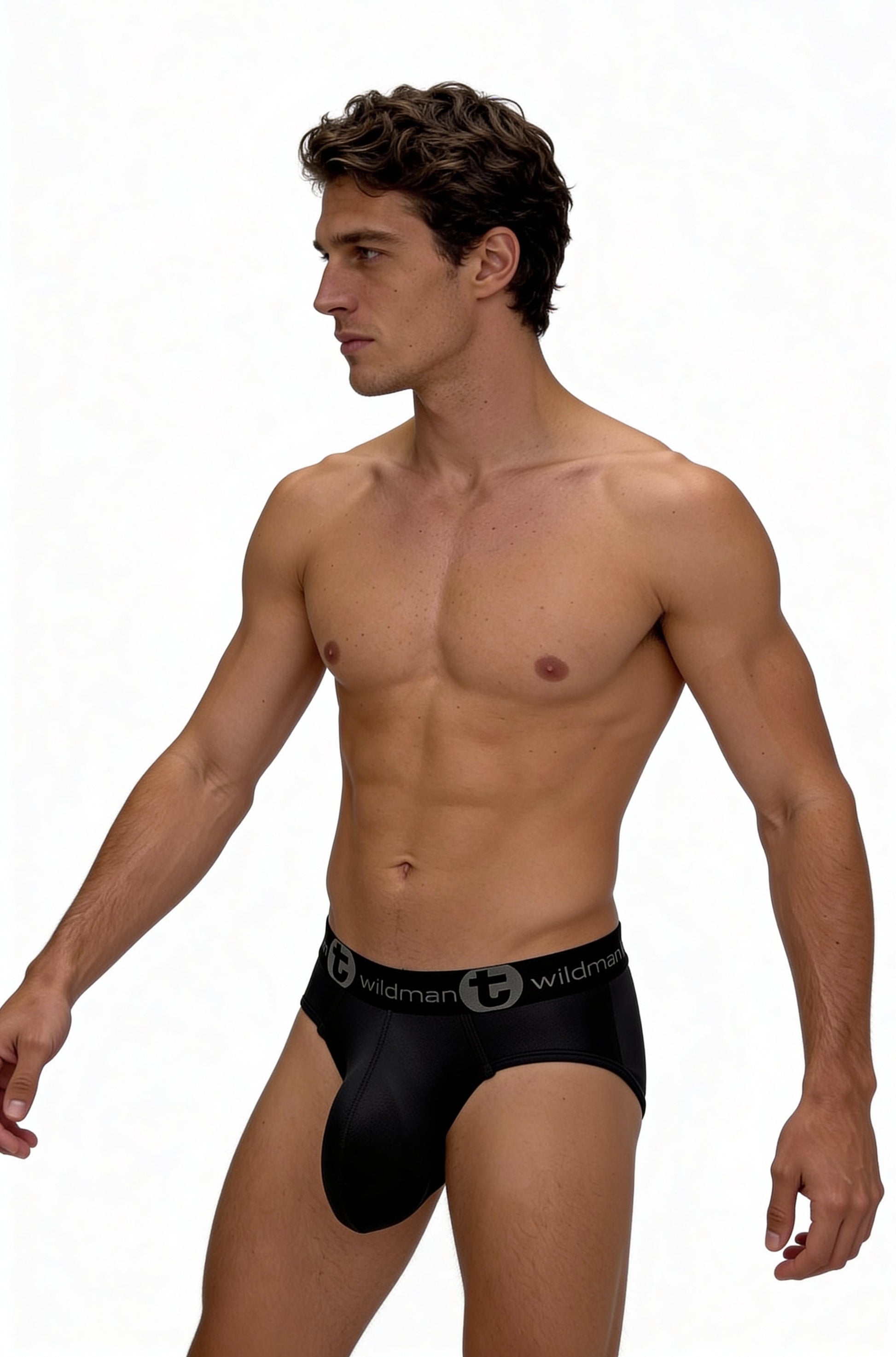 Man wearing black mesh WildmanT monster pouch briefs with a branded elastic waistband against a white background.