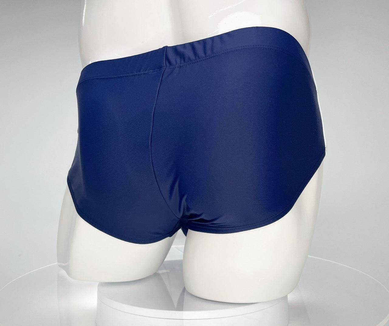 Back view of WildmanT Monster Cock navy swim brief on a white mannequin.