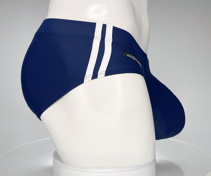 Navy blue swim brief with double white side stripes and a prominent contoured front pouch on a mannequin.