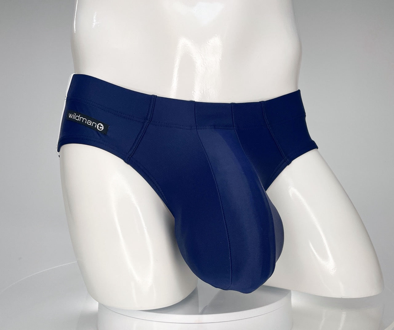 Navy WildmanT swim brief with a contoured pouch on a white mannequin torso.