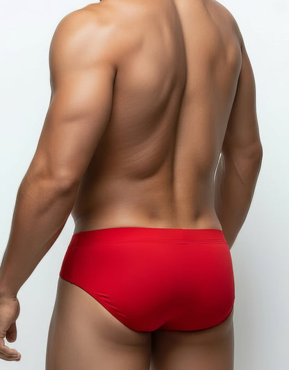 Back view of a muscular man wearing red Big Boy Pouch mesh briefs against a white background.