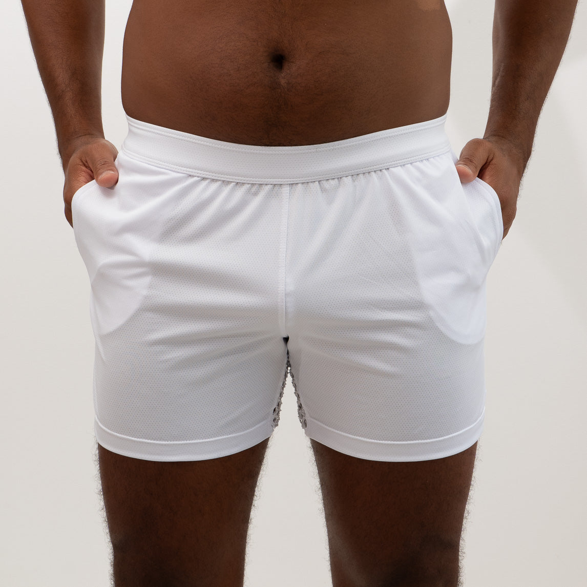 White athletic mesh back short with textured fabric and subtle side panel detailing for sports and workouts