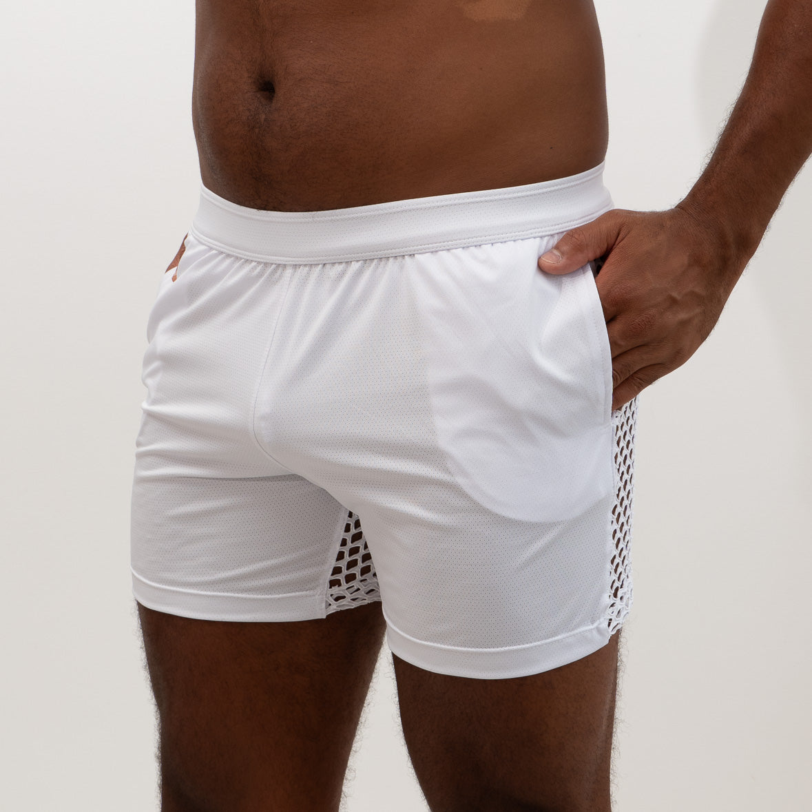 White athletic mesh back short featuring a solid fabric main body with a side mesh panel for breathability