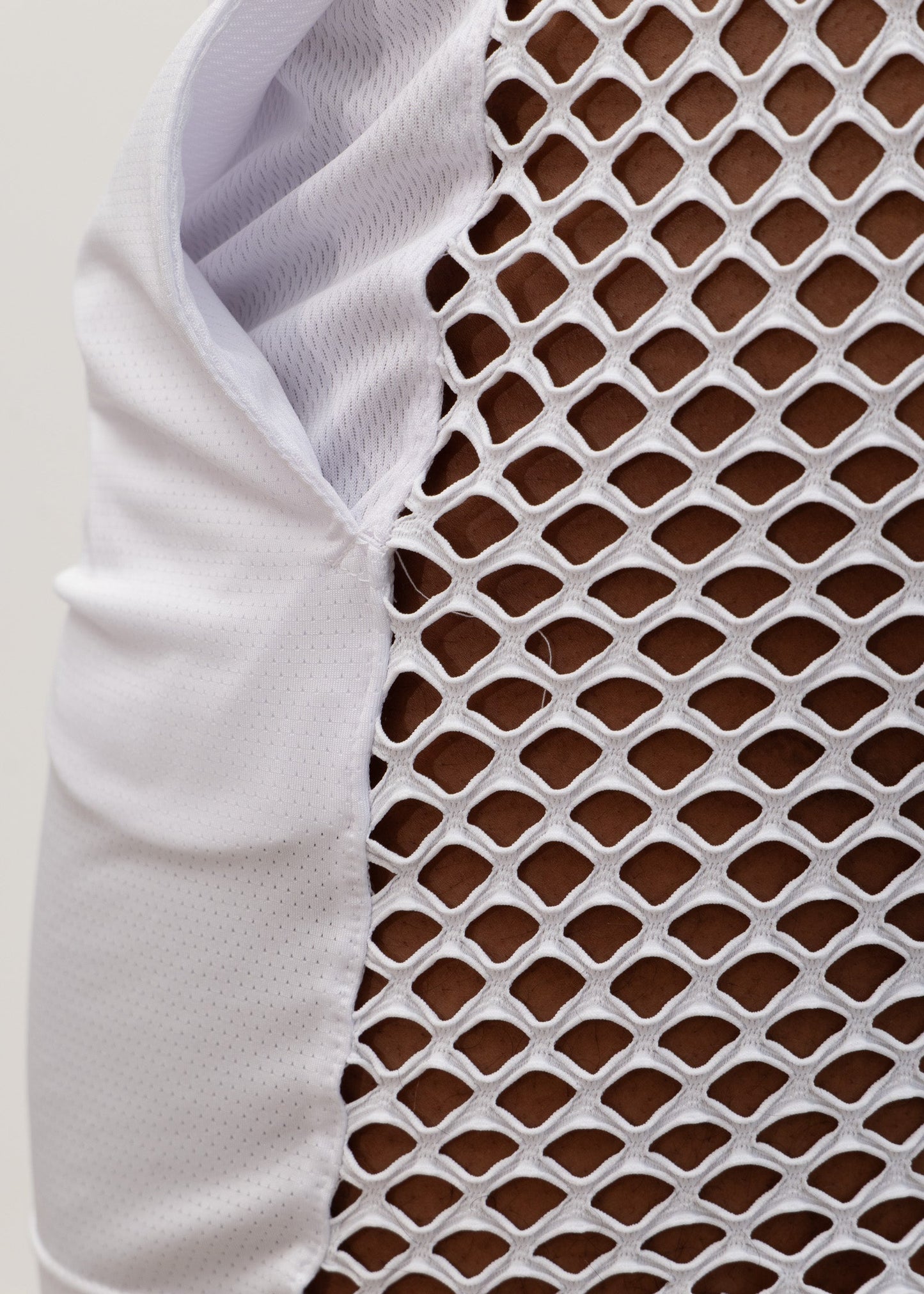 White mesh back short athletic vest with breathable diamond pattern and solid fabric arm panel for ventilation