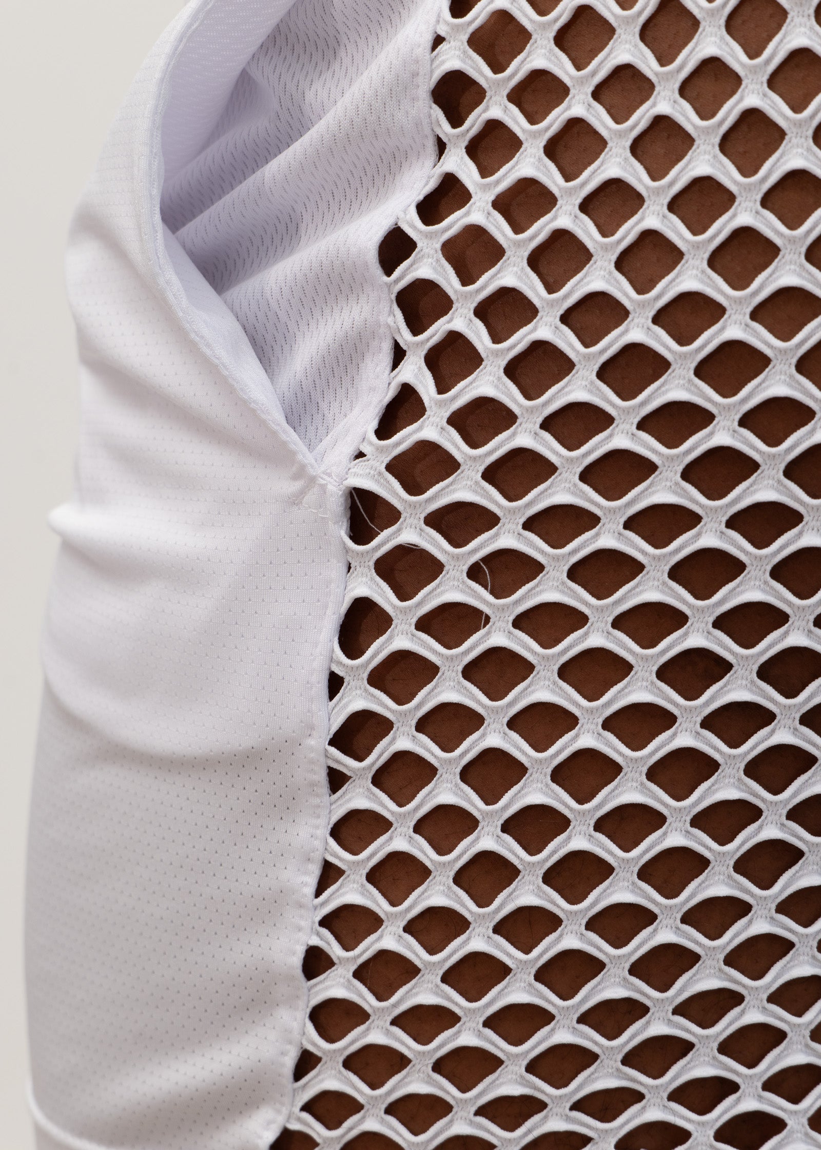 White mesh back short athletic vest with breathable diamond pattern and solid fabric arm panel for ventilation