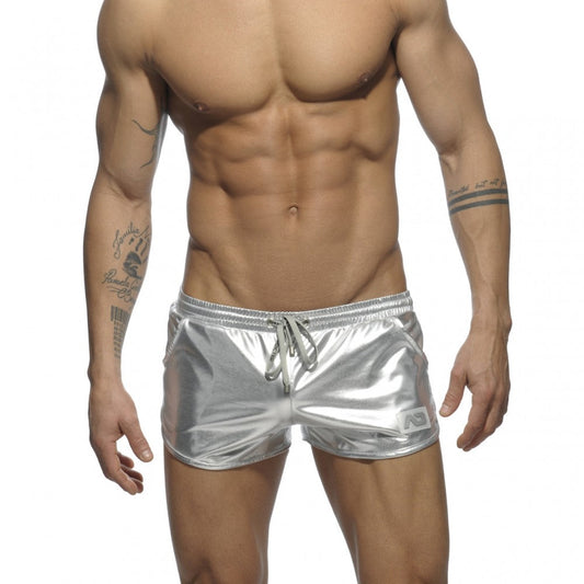 Metallic short shiny silver metallic swim trunks with drawstring waistband and small logo on lower right leg