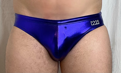 Vibrant royal blue metallic swim brief with a sleek shiny finish and small white logo on the waistband