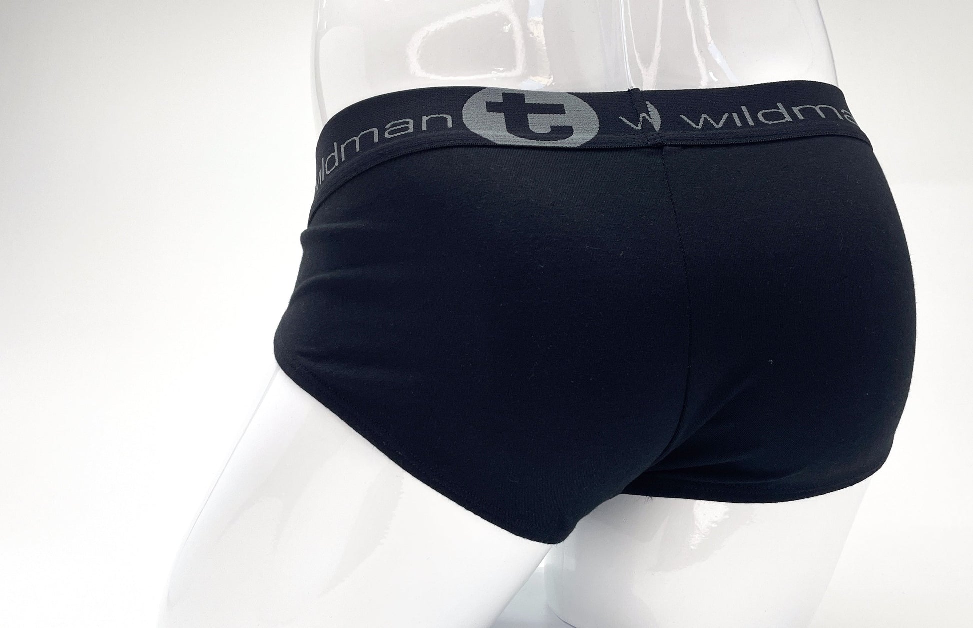 Back view of black stretch cotton pouch briefs on a mannequin, featuring a grey waistband with "wildman" branding.