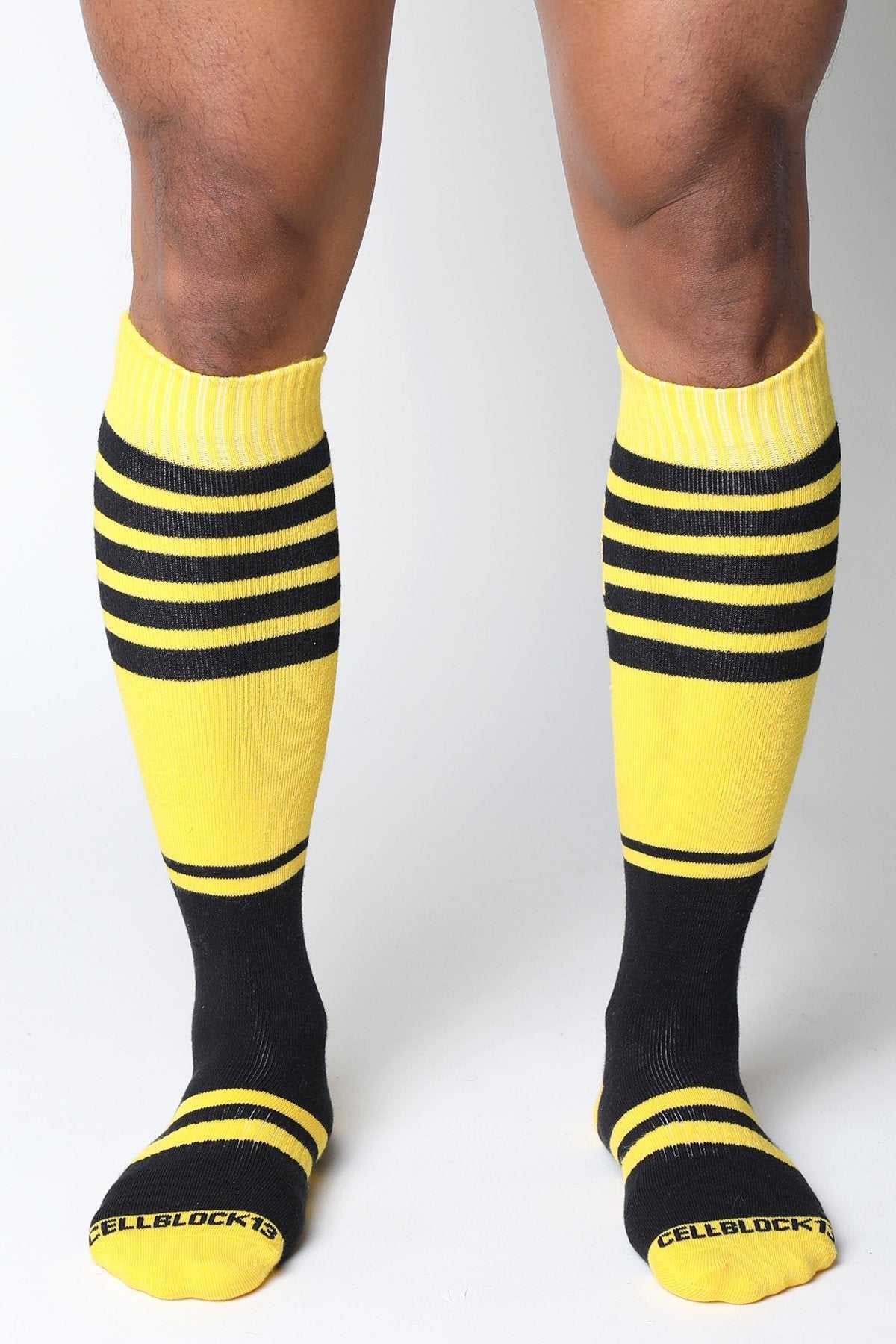 Midfield knee high sock in bright yellow and black stripes with ribbed texture and cellblock13 logo on the toe