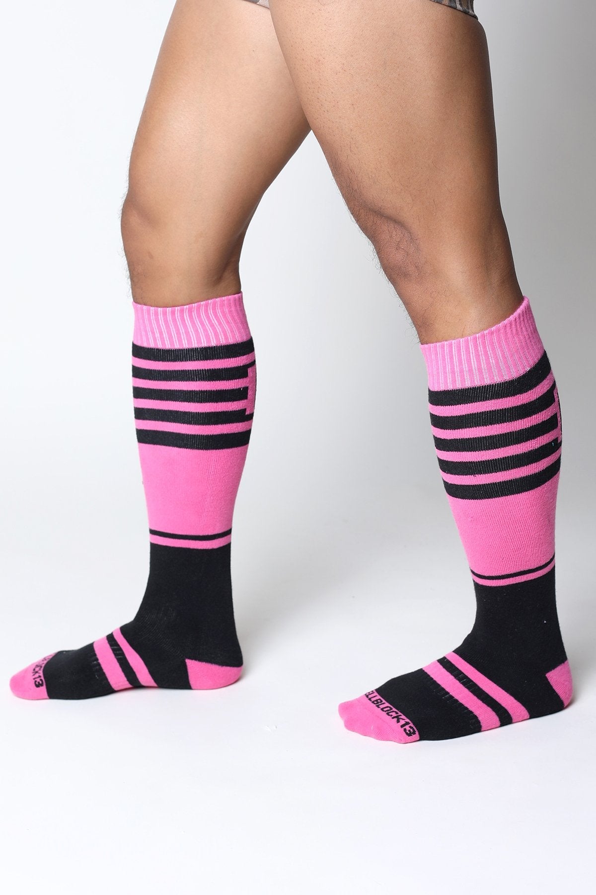 Midfield knee high socks in bright pink and black stripes with ribbed cuff and blueberries embroidered on the toe