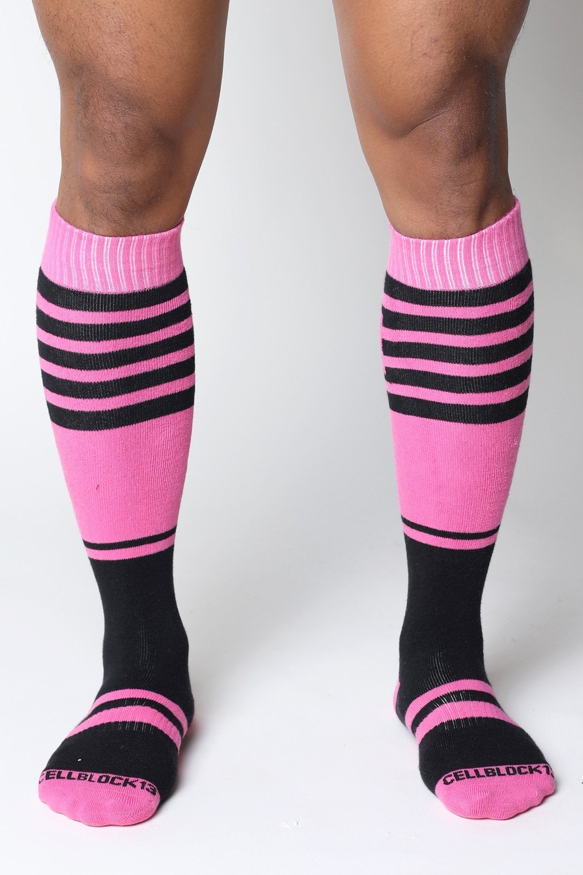 Midfield knee high sock in pink and black stripes with ribbed cuff and cellblock13 logo embroidered on toe