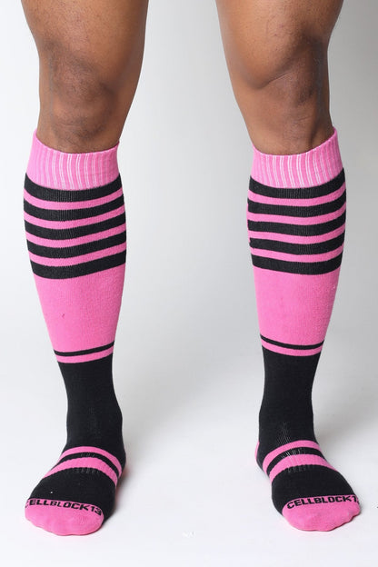 Midfield knee high sock in pink and black stripes with ribbed cuff and cellblock13 logo embroidered on toe