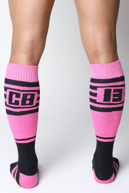 Midfield knee high socks in bright pink and black with bold cb lettering ribbed cuffs and toe accents