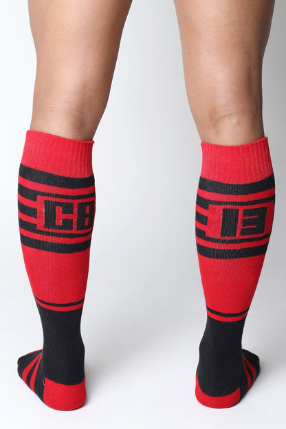 Midfield knee high socks in red and black with bold stripes and a cb logo on the calf in 7 colors