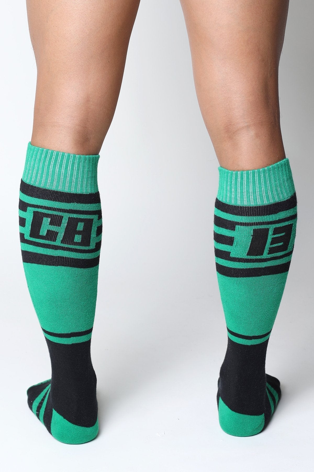 Midfield knee high socks in green and black with bold lettering on the calf designed for athletic use