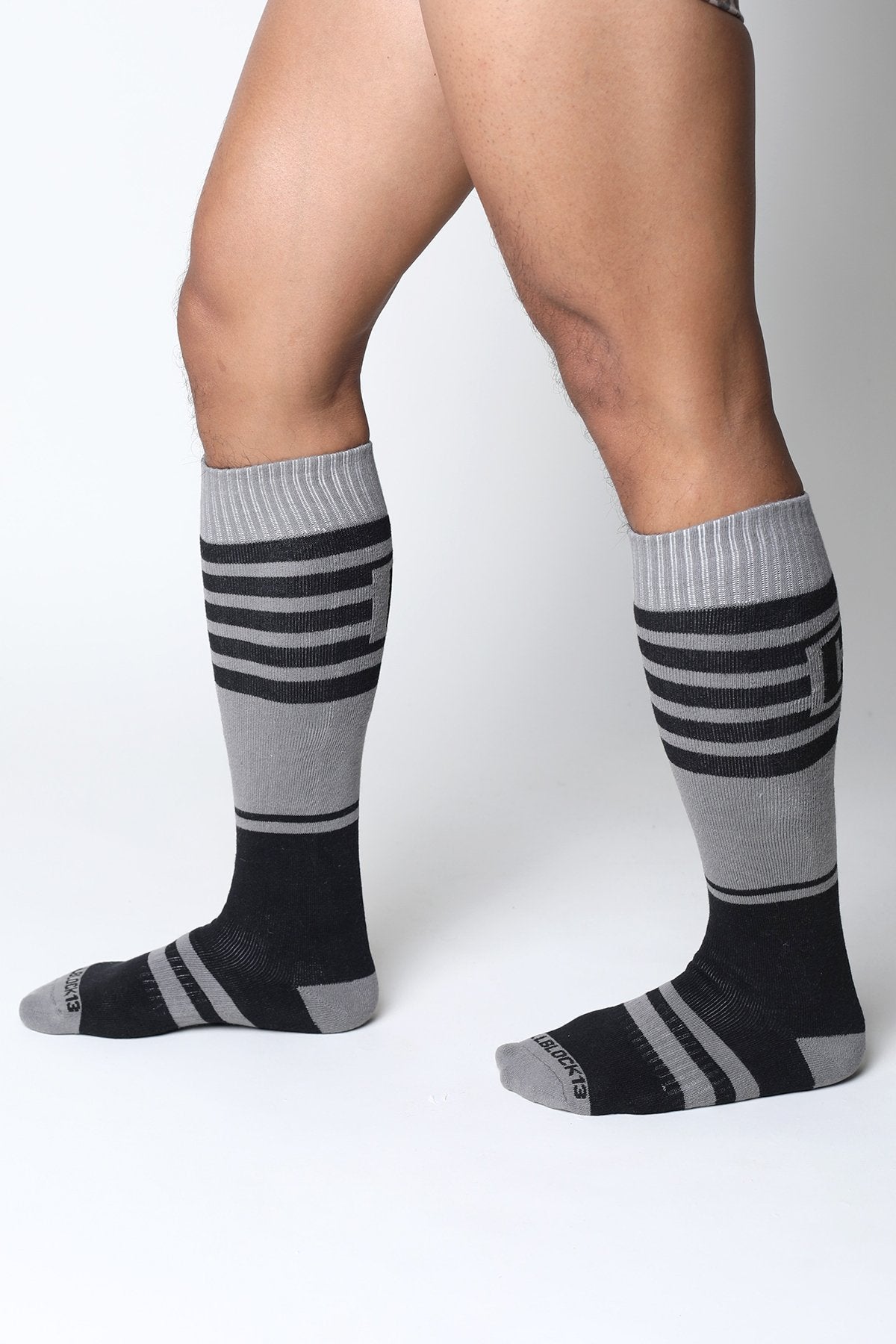 Midfield knee high socks in black and gray stripes with ribbed cuff made for comfortable all-day wear