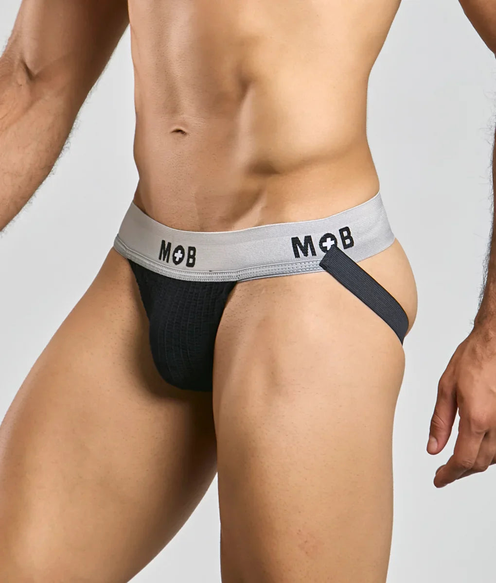 Black mob classic jock briefs with gray waistband featuring mob logo and black side strap shown from the back side
