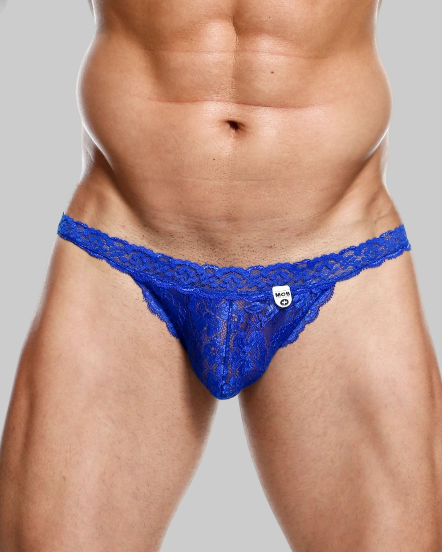 Blue lace thong with intricate pattern and small white brand tag from MOB mens lace waist thong collection
