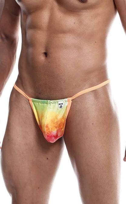 A vibrant tie-dye thong g-string in green yellow orange and red with peach elastic straps from mob print final sale