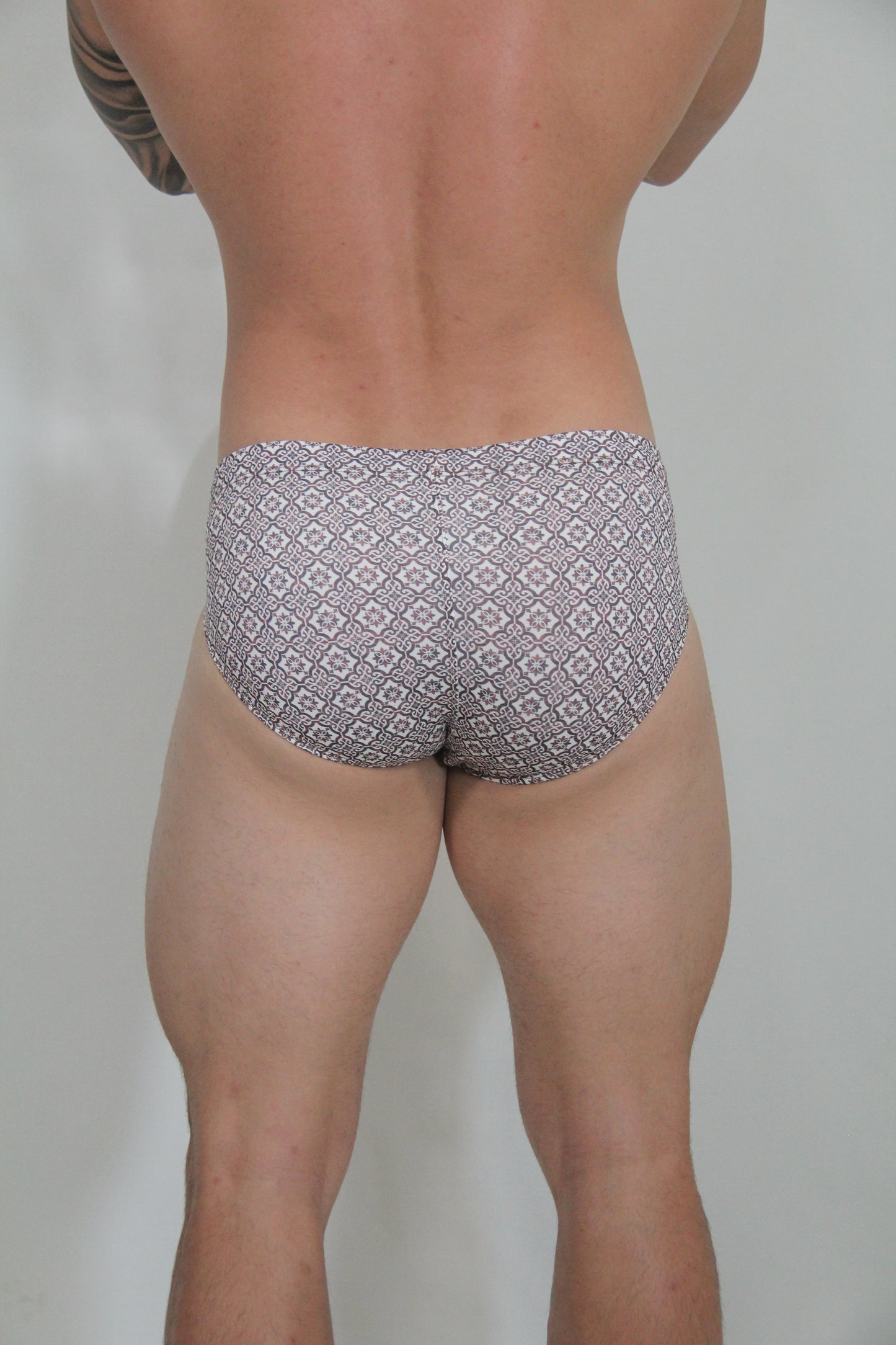 Gray and white patterned geometric mosaic swim brief with a comfortable fit for swimming and beachwear