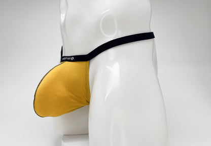 Gold WildmanT modal micro thong with a large pouch and black waistband on a white mannequin torso.