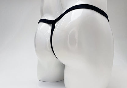 Black WildmanT modal micro thong on a white mannequin, showing a minimalist T-back design.