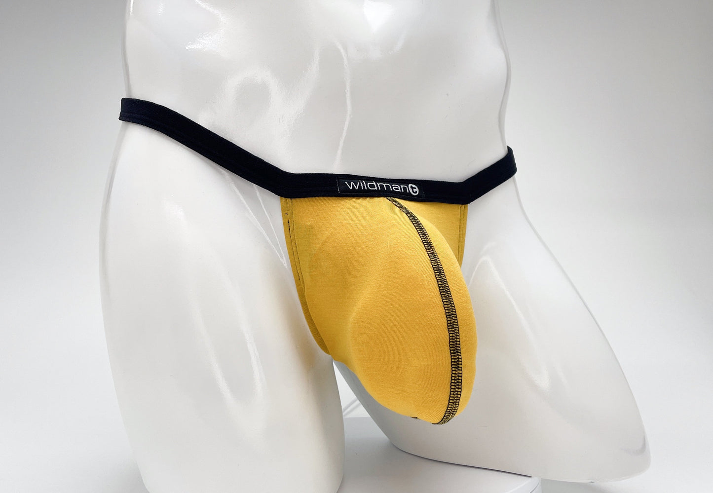 Gold modal micro thong with a large pouch, black waistband, and contrast stitching on a white mannequin torso.