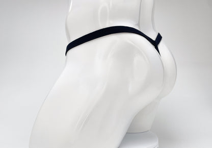 A dark purple WildmanT modal micro thong on a white mannequin, showing the rear T-back style.