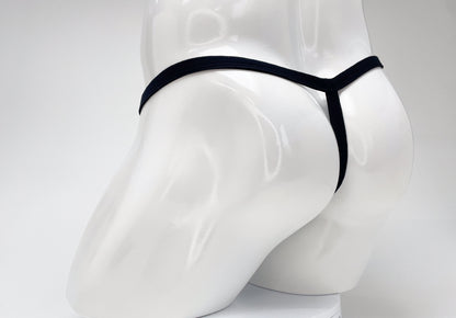 Rear view of a purple WildmanT Modal micro thong on a white mannequin torso, showing the thin waistband and T-back.