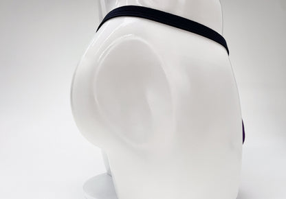WildmanT purple modal micro thong with a thin black waistband on a white mannequin torso.