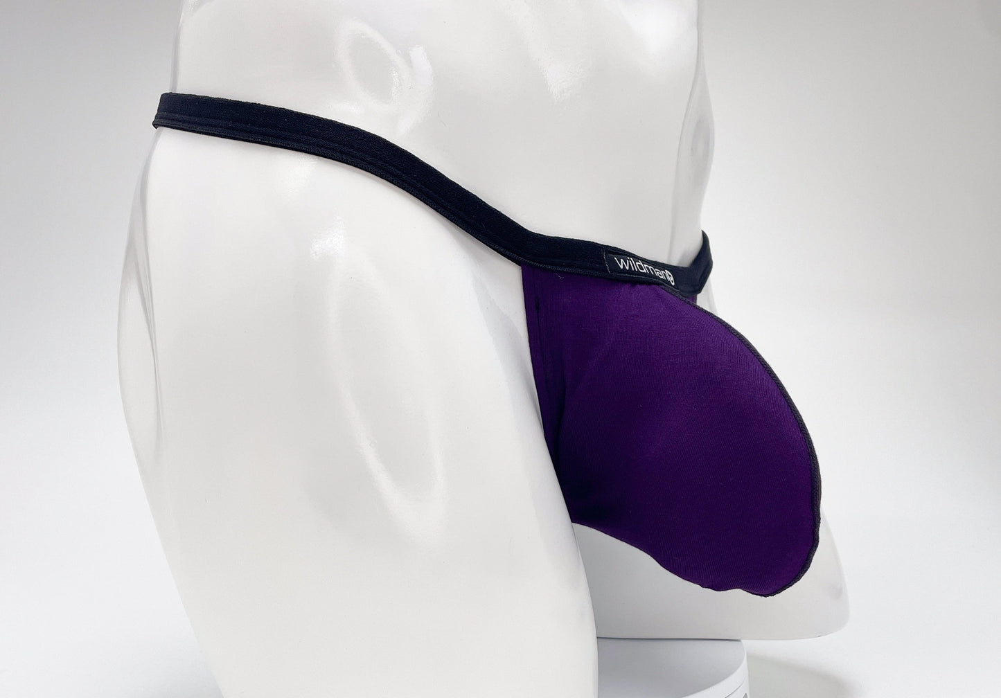 Purple WildmanT modal micro thong with a prominent pouch, black trim, and "WildmanT" logo on a white mannequin.