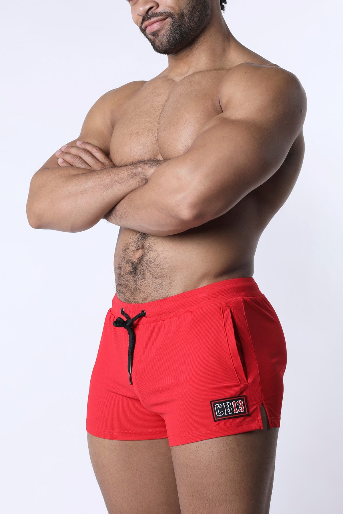 Muzzle up athletic short in red with black drawstring and small rectangular patch on the side for sports use