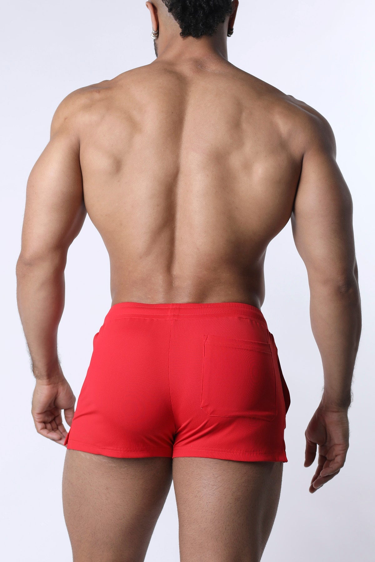 Red muzzle up athletic shorts with ribbed texture and side pockets designed for active wear