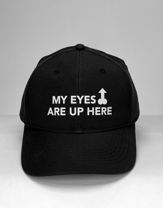 Black baseball cap featuring white text reading "MY EYES ARE UP HERE" with a phallic-shaped arrow graphic.