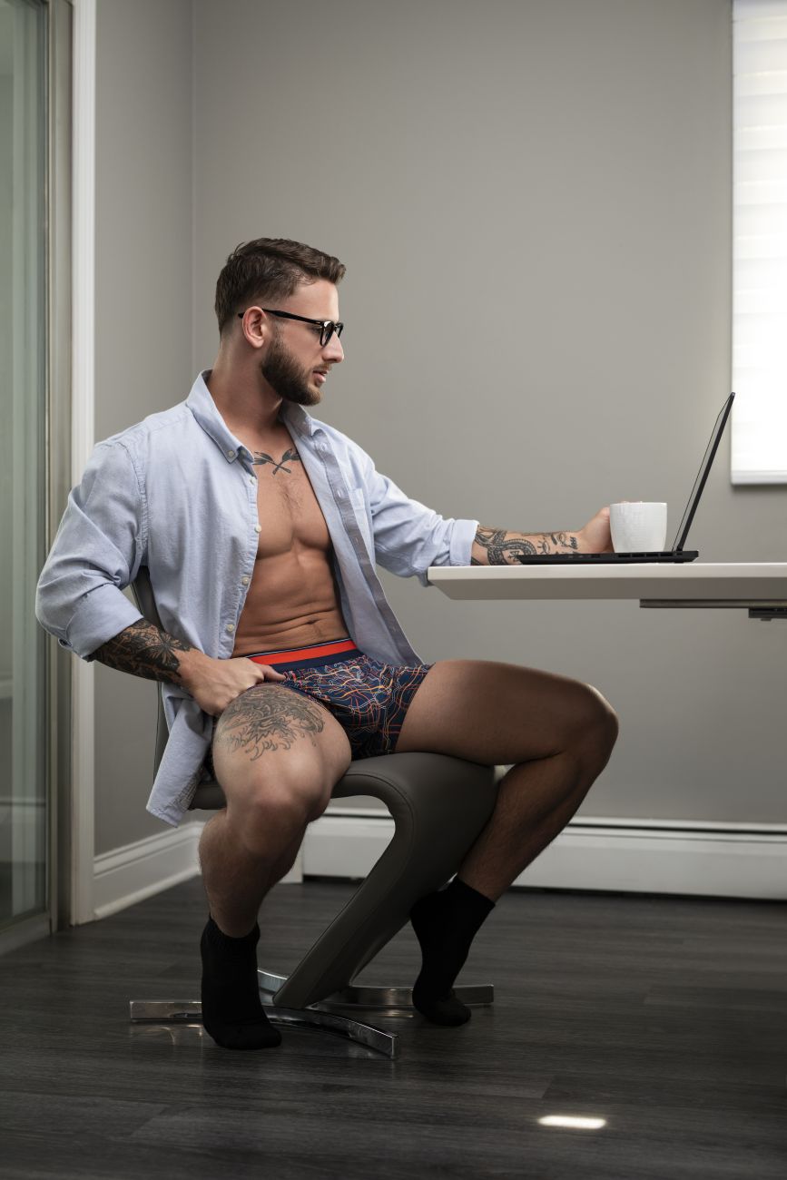 Man wearing male power 160-299 soo cumfy navy-orange patterned boxer briefs with red waistband from front view