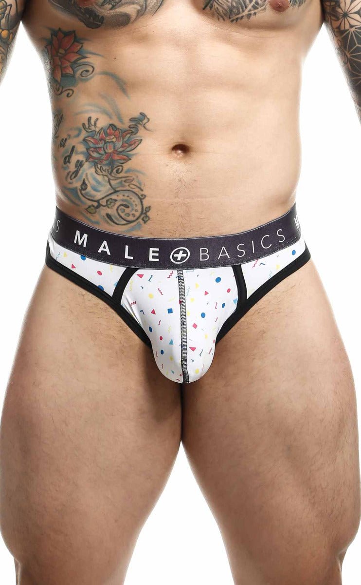 White malebasics mens thong with playful pink blue yellow confetti pattern black trim and logo waistband pouch design