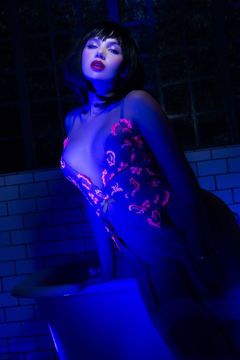 Mapale 80011 bodysuit in hyacinth reverie featuring a dark sheer fabric with vibrant pink embroidered floral patterns