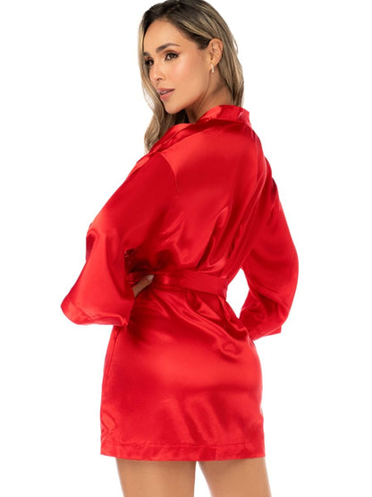Model wearing a shiny red satin robe with long wide sleeves and a matching tie belt.