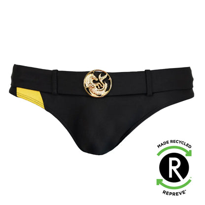 Black men's swim briefs with a gold medallion detail and yellow side panel made from recycled material by Maris Equi